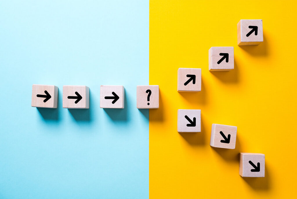 Wooden blocks with arrows pointing right end at a question mark block, then continue upward as arrows pointing diagonally up-right, illustrating a decision point that leads to growth.